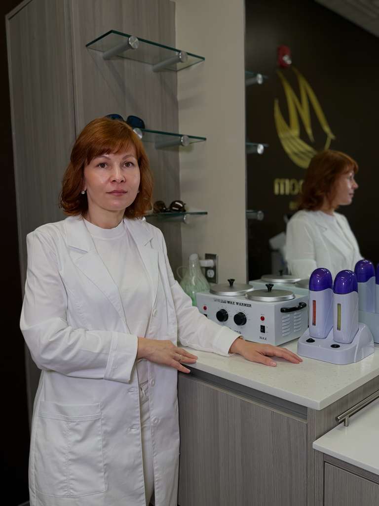 Marianna standing beside professional waxing equipment at Epilroom